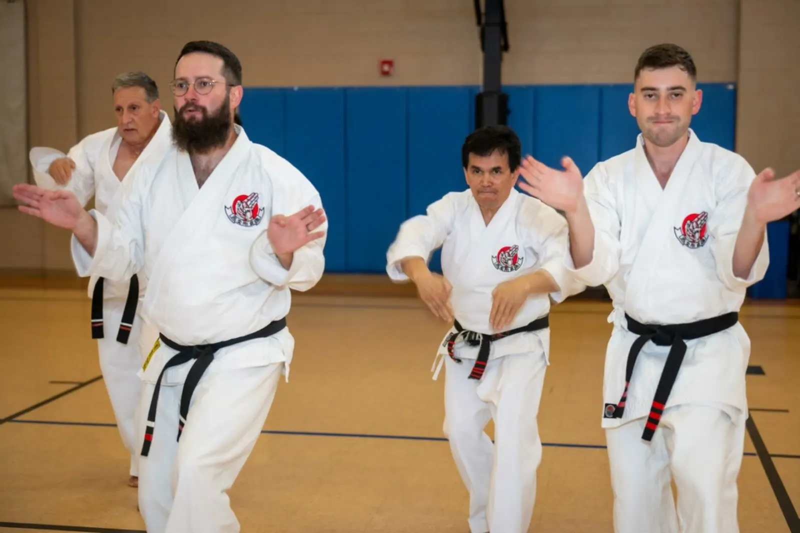 Kanzen Goju-Ryu black belts performing a front kick in unison